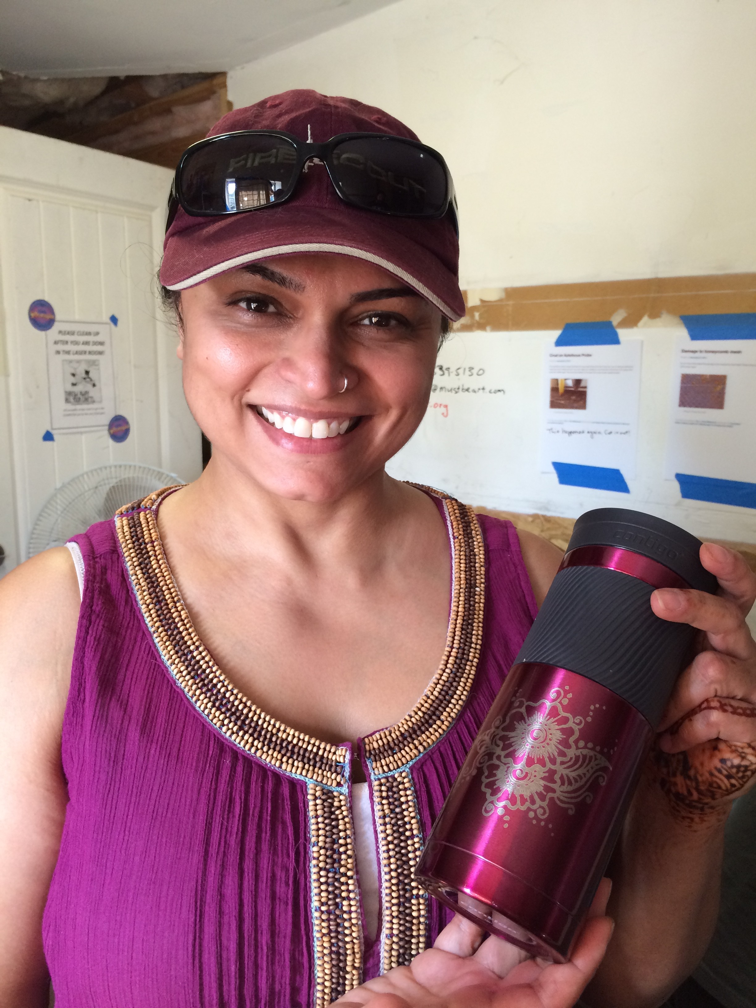 Sonie showing off her anodized aluminum water bottle with the henna pattern freshly engraved on the rotary adapter.